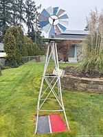 Full view of painted metal windmill on lawn
