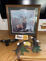 Framed print and both eagle sconces on tabletop