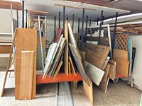 Full view of assorted wood and plastic pieces stored vertically on rack