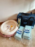 Group shot of carrier, bed, water bottle box, two pad packs