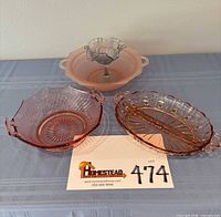 Group shot showing all three pink depression glass dishes and smoke gray ruffled compote