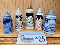 Front view of all five steins showing relief artwork and pewter lids