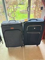 Front view of both 28-inch suitcases standing side by side