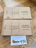 Two sealed cardboard boxes labeled Full Motion TV Wall Mount Model PIMFK3