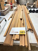 Stack of assorted wood molding pieces on table