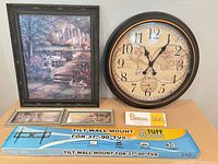 Group shot: framed garden print, wall clock, two small prints, sealed TV mount