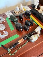 Group shot showing elephants, bear, dogs on base, and smoking pipe