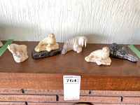 Group shot of all five stone animal figurines on shelf