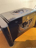 Full view of chest showing carved front panel and brass hardware