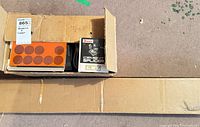 Cardboard box open with Prinz movie reel box and LPL splicer box inside