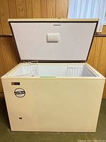 Freezer lid open showing exterior, interior and baskets