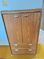 Front view of light oak veneer armoire with two doors and two drawers
