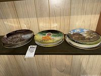 Three stacks of decorative plates on shelf