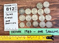 All 18 coins laid out with measuring tape and note showing "Before 1947 – one shilling"