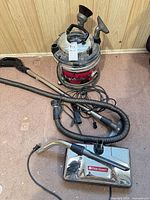 Canister vacuum with hose, powerhead and attachments