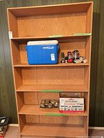Front view of oak-finish engineered wood bookcase with shelves