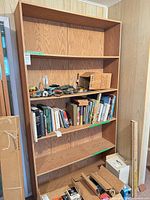 Front view of oak veneer bookcase showing shelves and overall design