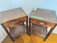 Pair of identical dark brown nightstands side by side