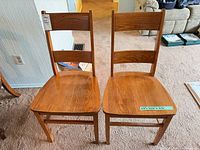 Front view of both oak ladder back chairs