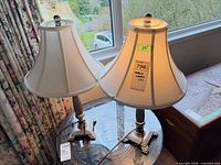 both lamps with shades illuminated on table