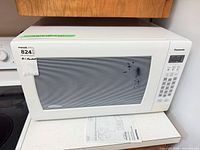 Front view of Panasonic white microwave showing entire unit on countertop