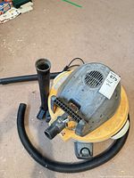Top view of RIDGID vacuum showing motor housing, hose connection, extension wand