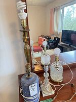 Four table lamps grouped on dresser