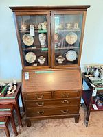Secretary desk closed; shows glass-door hutch and drop-front