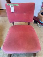 Front view of pink velvet side chair showing seat, backrest with buttons, wood legs