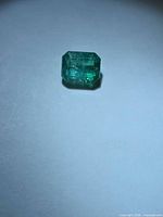 Top view of the octagon-cut emerald showing color and inclusions