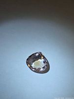 Top view of faceted pear-shaped ametrine