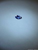 Top view of oval cut tanzanite showing color and facets