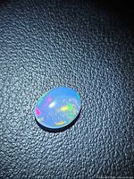 Front view of oval crystal opal showing play-of-color