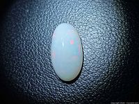 Front view of oval opal showing play-of-colour