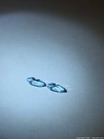 Pair of marquise-cut sky blue topaz on flat surface