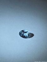Front view of oval-cut aquamarine on neutral background