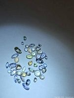 Group of loose multicolored Tanzanite gemstones on white background