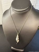 Full view of silver ball bead necklace on display bust