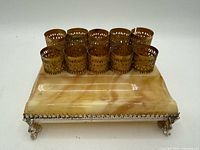 top view showing ten brass filigree holders and onyx base