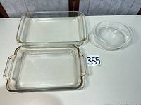 All three glass bakeware pieces arranged: two rectangular dishes, one round bowl