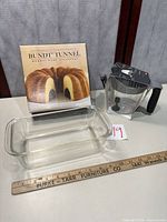 Bundt Tunnel box, OXO 2-cup measuring cup, additional glass pan present but not listed