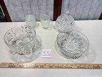 Group shot of five clear pressed glass pieces