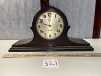 Front view showing entire clock, dial, case shape and scale with ruler