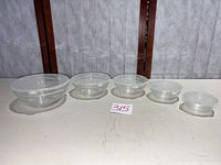 All five glass bowls with lids displayed in size order