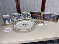 Dinner plate, three snowman mugs, boxed set of four Santa mugs, four dessert forks overview
