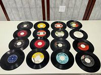 All 16 singles laid out in four-by-four grid showing label variety and quantity