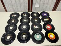 Full view of all sixteen 45 RPM records arranged in four-by-four grid