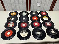 All 16 records laid out to show quantity and general condition