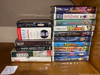 Full lot showing two stacks of VHS tapes, titles visible
