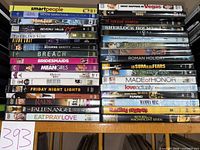 Two stacks of DVD cases on shelf showing lot contents